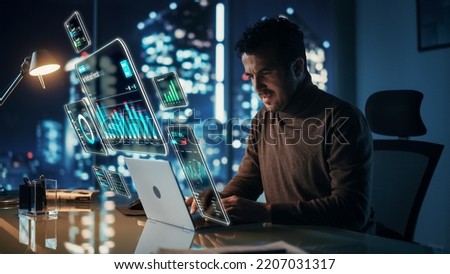 Executive Officer Working on Computer in Office at Night. Augmented Reality Corporate, Financial and Business App Icons Appear From Manager's Laptop. Internet and Online Productivity Concept. Stock fotó © 
