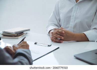 Executive sitting on the desk. Read Employee Resignation Letter and signs the resignation letter for the employee.changing and resigning from work concept for quit or change of job leaving the office