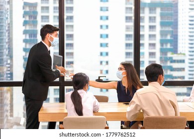 Executive Team Meeting During Coronavirus Or Covid-19 For Business New Financial Strategy After Pandemic With All Staff Members Wearing Facial Mask As Of New Normal And Social Distancing Policy