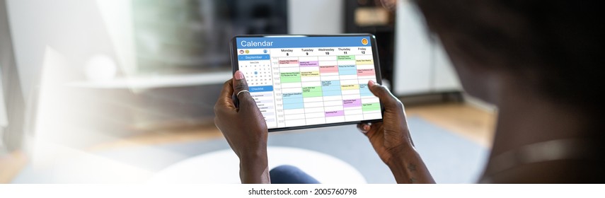 Executive Using Digital Calendar Agenda On Tablet