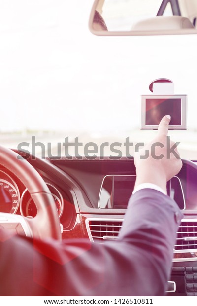 Executive using GPS\
navigation inside car\
