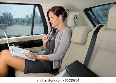 Executive Woman Manager Working On Laptop Sitting Car Leather Backseat