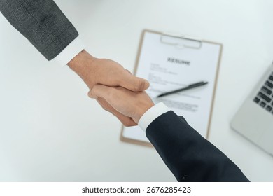 Executives accept job application and shake hand, documents and job applicants resume to match the position. company publishes vacancies online to find human. Human resource, interview, letters.