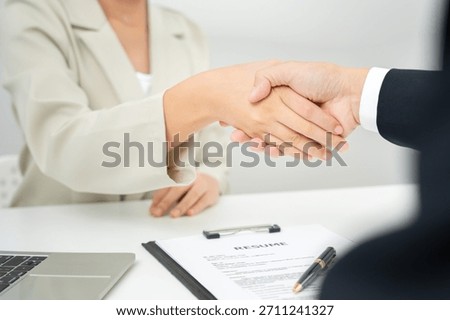 Executives accept job application and shake hand, documents and job applicants resume to match the position. company publishes vacancies online to find human. Human resource, interview, letters.