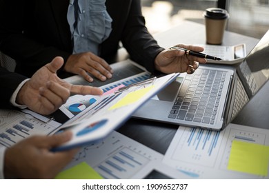 Executives and accountants are holding company financial statements and discussing them together, accountants are discussing corporate finance meetings to management. Financial concept.