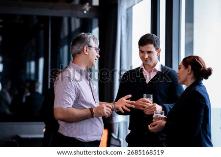Executives connecting during discussion at event in a hotel lounge, symbolizing innovation, negotiation, and the importance of professional relationships.