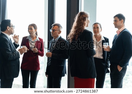 Executives connecting during discussion at event in a modern hotel lounge,symbolizing innovation,partnership,business connection,empathy,negotiation and the importance of professional relationships.