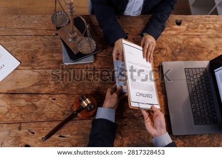 Executives engaging in an illegal transaction by exchanging money for signing a confidential contract, representing corporate corruption, fraud, and unethical business practices