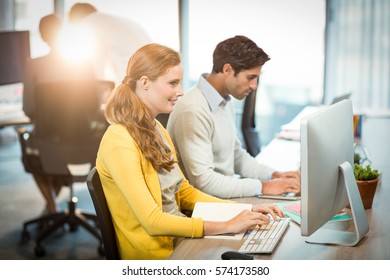 Executives working on laptop in office