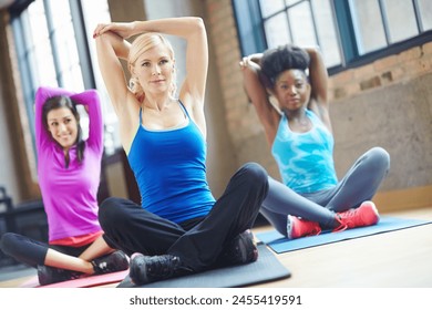 Exercise, arm stretching and women with yoga mat for training, fitness and warm up on floor. Diversity, happy and group of friends getting ready for flexibility workout, pilates or wellness in gym - Powered by Shutterstock