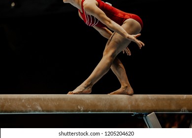 exercise balance beam female gymnast on black background