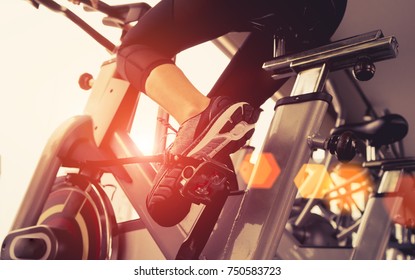 Exercise Bike Cardio Workout At Fitness Gym Of Woman Taking Weight Loss With Machine Aerobic For Slim And Firm Healthy In The Morning, Athlete Builder Muscles Lifestyle.