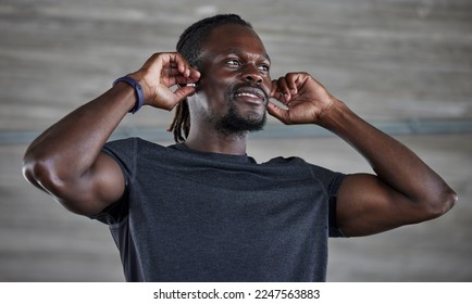 Exercise, black man and earbuds for music, wellness and motivation for fitness, cardio or muscle power. African American male, athlete or earphones for podcast, radio or workout to relax or streaming - Powered by Shutterstock