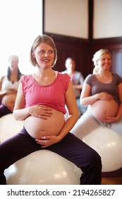 Exercise Class, Pregnant Mother Fitness And Women Workout At Maternity Wellness Care Studio. Happy Woman With Pregnancy Belly On Gym Ball With The Motivation For A Strong And Healthy Body.