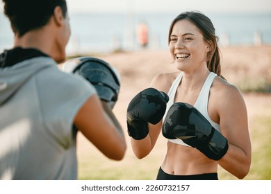 Exercise, happy woman and personal trainer and boxing outdoor at park for fitness, health and wellness. Couple of friends for nature sports workout or fight training with motivation, energy or coach - Powered by Shutterstock