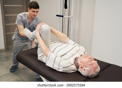 Exercise for legs done by senior male with doctor help - Powered by Shutterstock