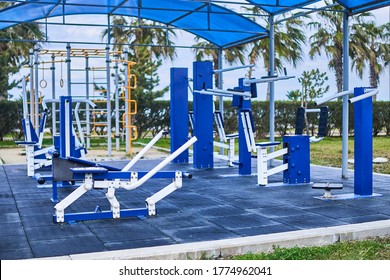 Exercise Machines And Fitness Equipment In The Street Outdoor Gym In City Park           