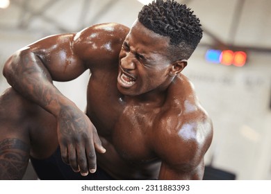 Exercise, muscle and pain with a black man bodybuilder breathing in the gym, exhausted after a workout. Fitness, injury and sweat with a intense, shirtless male athlete taking a break from training - Powered by Shutterstock