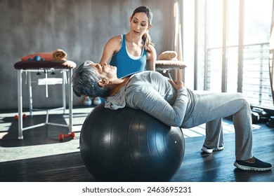 Exercise, physiotherapist and elderly woman with ball in clinic for rehabilitation, support or stretching. Injury, healthcare worker and senior patient for balance, recovery help or physical therapy - Powered by Shutterstock