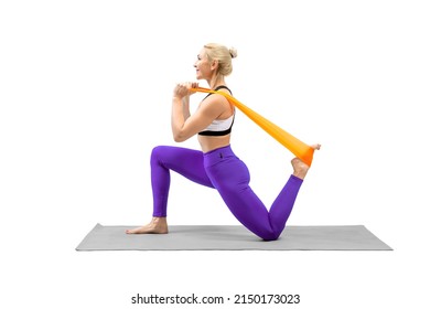 Exercise with resistance band. Caucasian fit woman stands on one knee and stretching her quadriceps, isolated on white. Pilates, yoga, fitness, sport advertising, workout, flexibility, healthy