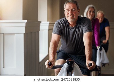 Exercise, spinning class and senior man in gym for cycling, fitness and training with physical activity. Workout club, team and people on bicycle for health, wellness and endurance with cardio - Powered by Shutterstock