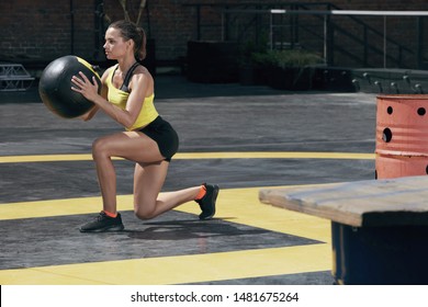 Exercise. Sport Woman Doing Leg Workout With Med Ball Outdoors. Fitness Girl With Fit Body Exercising, Doing Lunge Training With Medicine Ball On Street