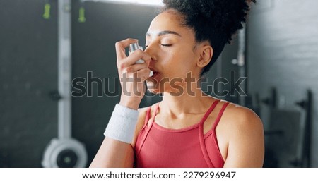 Exercise woman, asthma inhaler breathe at gym with fitness coach for chest relief and wellness. Black woman anxiety, asma attack sitting on floor at training workout for body health in Los Angeles