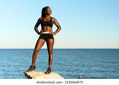 Exercise woman looking away while posing on beach. Fitness sport model smiling happy after outdoor work out on sunny summer day. Beautiful mixed race girl training outside  - Powered by Shutterstock