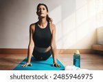 Exercise, yoga and workout with woman for health, cobra pose and wellness in home on floor. Lady, fitness and zen stretching for pilates, strength and core power for muscle and body training