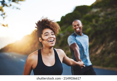 Exercising will only make you feel better. Cropped shot of a happy young couple out for a run together. - Shutterstock ID 2149036617