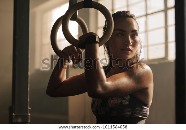 Exercising Woman Holding Gymnast Rings Looking Stock Photo