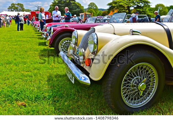 Exeter, Devon / England - 5/10/2019: Classic car\
show.A line of classic Morgan open-topped sports cars. One of few\
remaining British car manufacturers.Each is hand built in Malvern\
to customer\'s spec.