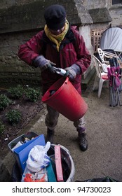 EXETER - FEBRUARY 4: Occupy Exeter Ghee Bowman Clears Away Rubbish From Exeter Cathedral Green, Following The Eviction Notice Served By The Cathedral Chapter  On February 4, 2012 In Exeter, UK