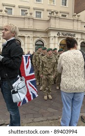 EXETER - NOVEMBER 16: A Man With A Union Flag And A Woman Watch The Parade During The Homecoming Parade For 3 Commando Brigade  On November 16 In Exeter, England