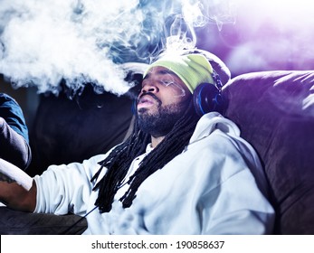 Exhaling A Big Puff Of Marijuana Smoke