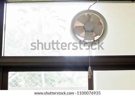 Exhaust fan mounted on the glass.