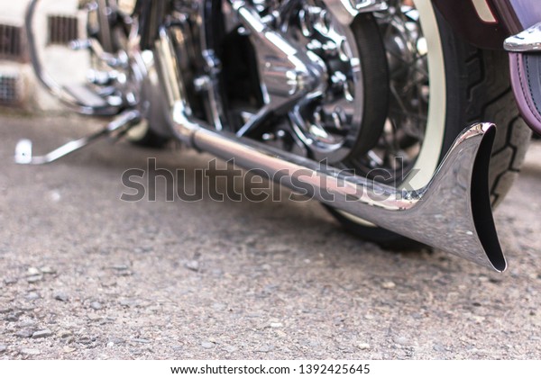 Exhaust pipe. Motorcycle tuning.\
Chrome-plated cruiser. Chopper with custom details. Original\
vehicle style. Straight lines on a classic\
motorcycle.
