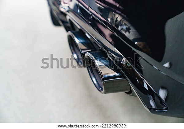 the exhaust pipe of\
the new black car. sale of modern luxury cars. dealership. sale and\
rental of cars.