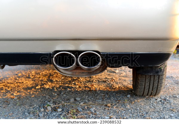 exhaust pipe of a silver gold car for carbon\
dioxide emissions