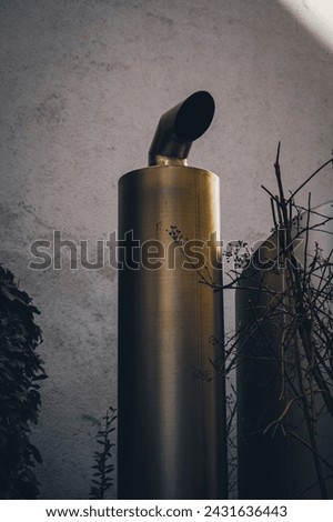 An exhaust pipe from a ventilation or air conditioning system in a residential building.
