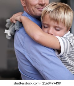 Exhausted After A Fun-filled Day. A Mature Father Coming Home From Work And Hugging His Exhausted Little Boy.