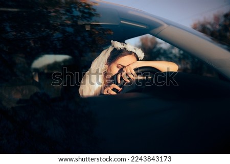 
Exhausted anxious Bride Crying Behind Steering Wheel. Upset married woman having an accident on her wedding day
