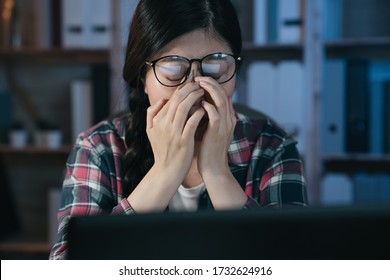 Exhausted Asian Korean Female Student Studying Online With Laptop Computer Suffering Eyestrain In Night At Home. Tired Stressed Young College Girl Massage Nose Bridge While Feelingeyes Painful.