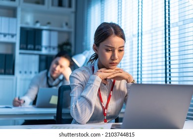 Exhausted Asian Sick Business Woman Worker Working On Table In Office. Busy Employee People Feel Tired And Headache From Late Of Work And Overwork Job Document On Computer Desk At Workplace At Night.