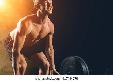 Exhausted Athlete Resting After Heavy Barbells Training