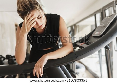 Exhausted athletic woman after her fitness workout in the gym