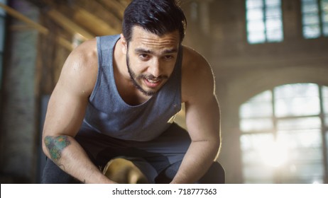 Exhausted Bend Muscular Man Rests After Intensive Workout. He's In a Gym and Covered in Sweat. - Powered by Shutterstock