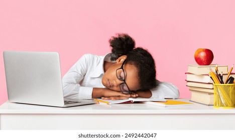 Exhausted Black Schoolgirl Sleeping At Laptop Computer Doing Homework On Yellow Background In Studio. School Overload Concept. Panorama - Powered by Shutterstock