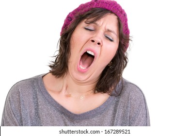 Exhausted Or Bored Woman Wearing A Knitted Beanie Yawning With Her Mouth Wide Open And Eyes Shut Isolated On White