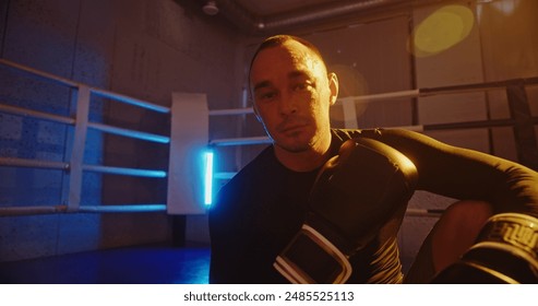 Exhausted Boxer Resting After Sparring Session in the Ring - Powered by Shutterstock